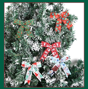 Detailed view of assorted Christmas bow ornaments with festive patterns on a snowy tree