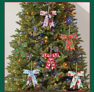 Close-up of decorative Christmas tree bows featuring festive snowman and Santa prints