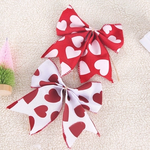 Handmade linen bows with red and white heart patterns for Valentine or party decoration