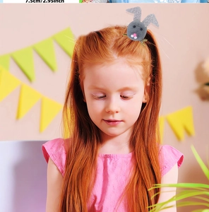 Dettaglio di una bambina con fermaglio per capelli a forma di coniglio grigio glitterato