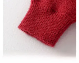 Close-up of red knit sweater sleeve with ribbed cuffs and soft fleece texture
