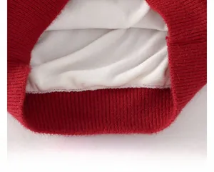 Detail of red knit sweater hem with warm thick fleece lining and ribbed elastic cuff