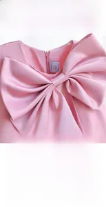 Detail of pink satin princess dress featuring a large bow and 5Y size tag on back