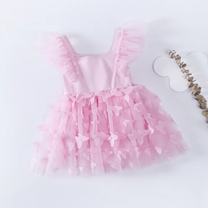 Detail of pink baby bodysuit dress with 3D butterfly appliques and soft mesh layers