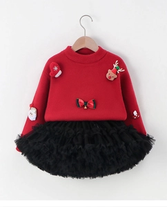 Detail of red knitted sweater with 3D Santa reindeer patches and black mesh tutu skirt