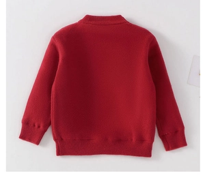 Detail of red festive knitted sweater showing ribbed cuffs and back neckline texture