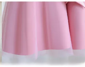 Detailed close-up of premium light pink tulle layers on a girl's princess gown dress