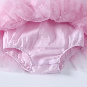 Detail of baby girl pink tulle skirt with integrated soft cotton diaper cover shorts