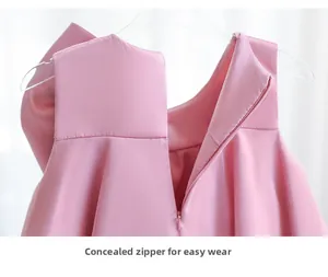 Detail of invisible back zipper on a smooth pink satin flower girl dress for parties