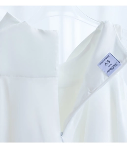 Detail of high-end white princess dress featuring KaQinini label and smooth back zipper