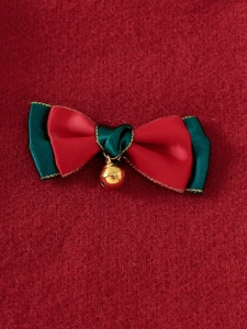 Festive red and green knit sweater for girls with a ribbon bow and golden bell detail