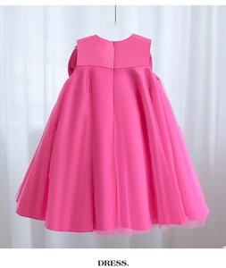 Detail of rose pink flower girl dress with satin bodice and layered tulle tutu skirt