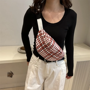 Red and white checkered crossbody waist bag with adjustable nylon strap and half-moon design