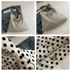 Detail shots of polka dot canvas tote with golden magnetic buckle and sturdy stitching