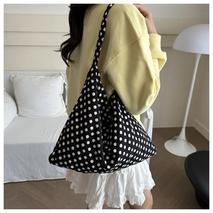 Polka dot canvas tote bag showing the spacious interior and drape on shoulder