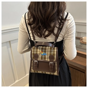 British style backpack with plaid fabric and cute dachshund embroidery shown on model