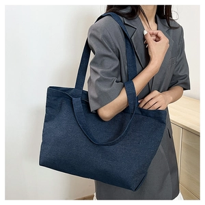 Detailed texture of high-capacity dark blue denim tote bag for daily commute