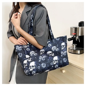 Gothic skull tote bag shown on a shoulder in a modern kitchen setting with soft lighting