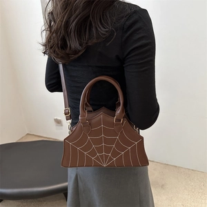 Brown faux leather saddle bag with spider web embroidery and adjustable shoulder strap