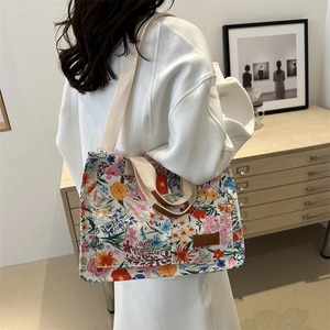 Floral canvas tote bag with wide straps and leather handles for casual commute use