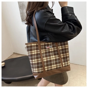 Model wearing vintage plaid tote bag with cute cartoon puppy patch and leather straps