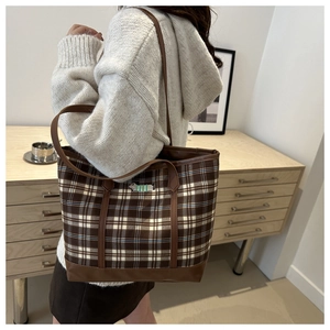Detailed close-up of brown checkered tote bag featuring a cute dachshund embroidery detail