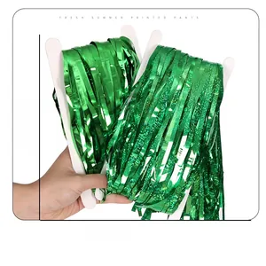 Detail of green foil fringe curtain for St. Patrick's Day party backdrop decoration
