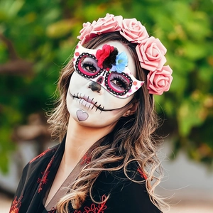 Detail of Day of the Dead eye mask with colorful 3D flowers on a skull makeup model