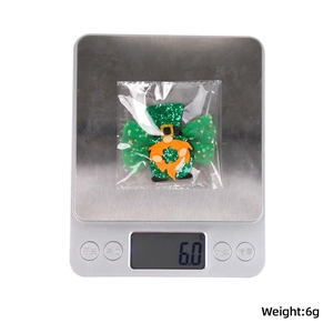 Detailed view of St. Patrick's Day gnome bow decoration weighing 6 grams on scale