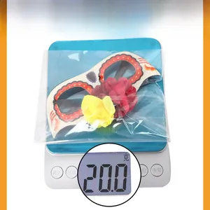 Close-up of a Day of the Dead flower skull mask glasses being weighed at 20 grams