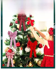 Close-up of glittery Christmas tree bow ornaments with red velvet and elk patterns
