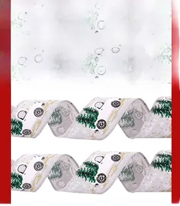 Detailed view of white Christmas ribbon with green trees and Merry Christmas print