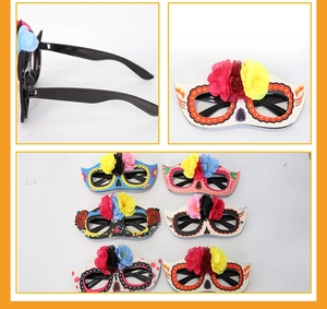 Detail view of colorful Day of the Dead mask glasses with artificial flowers and skulls
