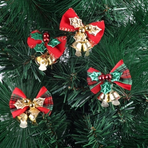 Set of four Christmas bows with gold bells and red berries on a green pine tree