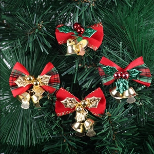 Set of 4 festive red and green plaid Christmas bows with gold bells on a Christmas tree