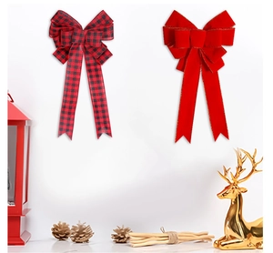 Close-up of buffalo plaid and velvet Christmas bows with festive pine cone decor