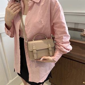 Beige vintage messenger bag with double buckles and top handle for elegant women