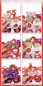 Detail of red glitter Valentine party glasses with LOVE and KISS motifs on white backdrop
