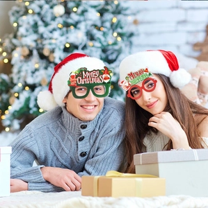 Detail showing two models wearing festive Merry Christmas themed paper glasses at a party