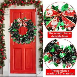 Christmas wreath with red berry accents and festive bow shown on a red front door