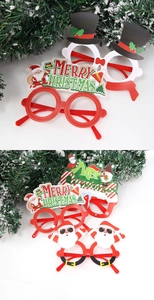 Close-up of Merry Christmas themed party glasses featuring cartoon reindeer and Santa motifs