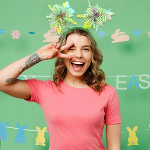 Detail of colorful pom-pom Easter headband with green tinsel ears for festive party decor