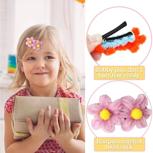 Close-up of pink flower hair clip showing plush twist stick texture and black metal base