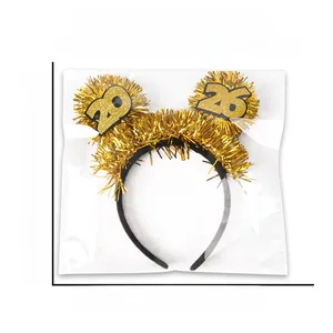 Detail view of 2026 New Year gold tinsel headband in packaging with dimensions shown
