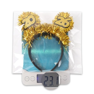Weight measurement of 2025 glitter New Year headband showing 23.1g on a scale