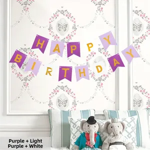 Detail of Happy Birthday banner with purple paper swallowtail flags and gold lettering