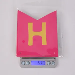 Weight measurement detail of pink swallowtail birthday banner showing 51g on digital scale
