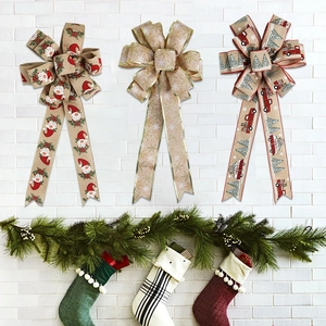 Detailed view of three festive faux linen Christmas bows with snowman and truck patterns
