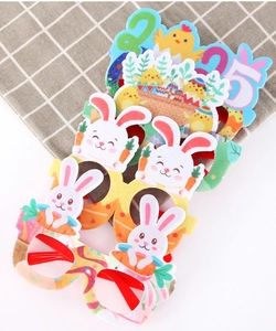 Close-up of colorful 2025 Easter party glasses with rabbit, chick and carrot felt designs