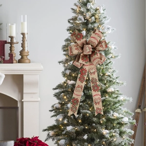 Detail of Christmas tree bow with Merry Christmas text and red poinsettia patterns
